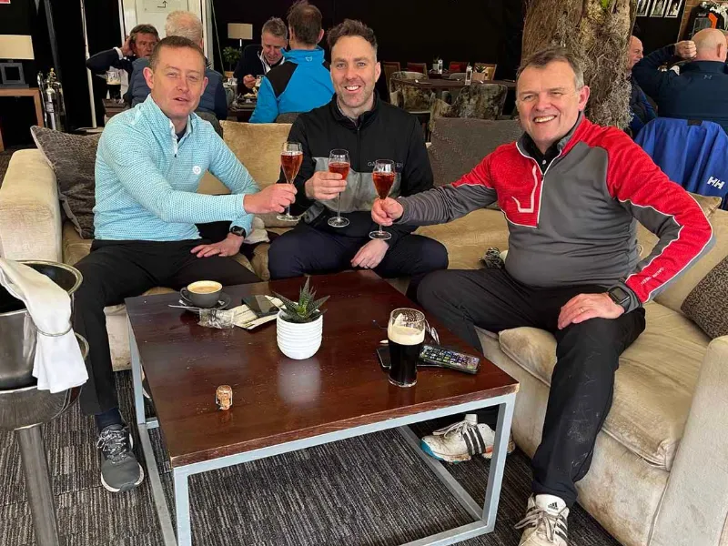 Celebrating at the 19th hole with his playing partners.