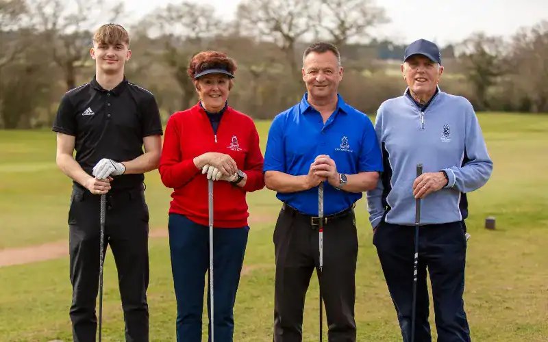 The four new officials (President, Captain, Lady Captain, Junior Captain) teeing off or posing together on the first tee