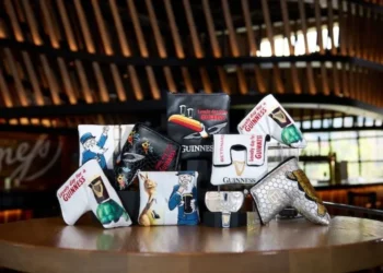 Bettinardi Golf & Guinness accessories on a table.