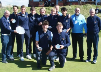 a group of golfers posing for a photo