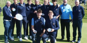 a group of golfers posing for a photo