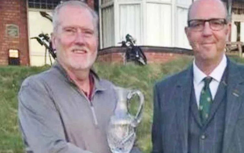 Gareth Bradley receives the trophy from Wallasey captain Dave Pennington.
