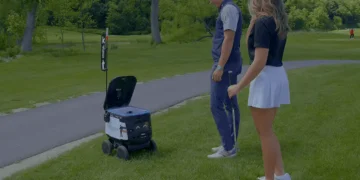 a man and woman standing on a golf course