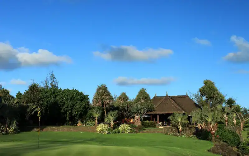 A golf course with a building and trees.