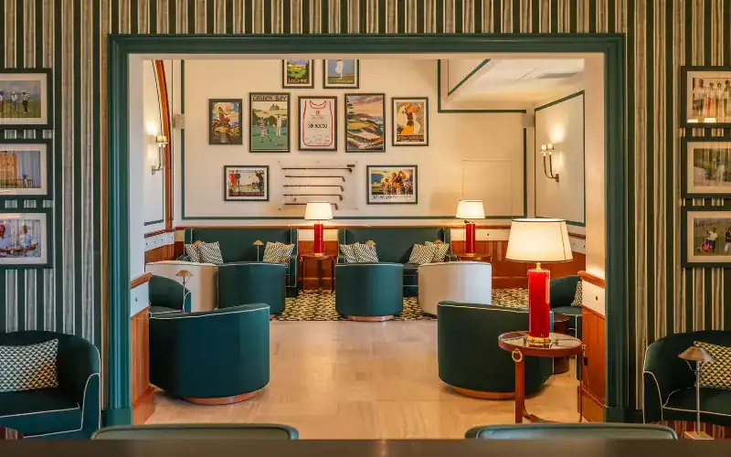 Verdura Resort’s new clubhouse interior featuring elegant seating, golf memorabilia, and vintage posters.