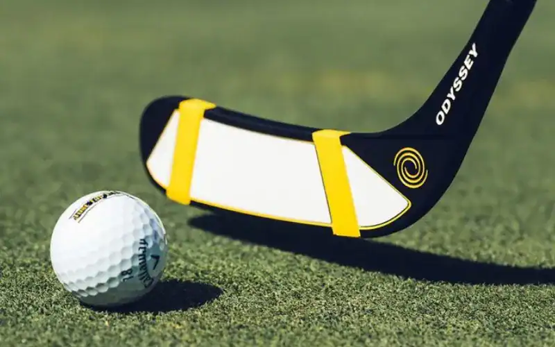 A Happy Gilmor Odyssey Hockey Stick Putter paired with a golf ball.