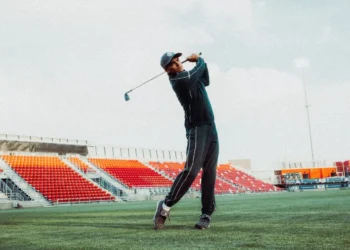 Rickie Fowler swinging a golf club.