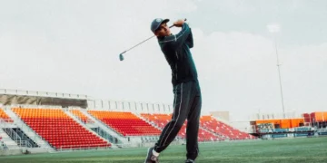 Rickie Fowler swinging a golf club.