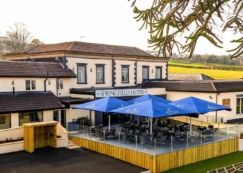 a building with a patio and umbrellas