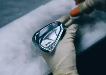A person holding a Srixon’s i-FORGED club.