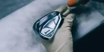 A person holding a Srixon’s i-FORGED club.