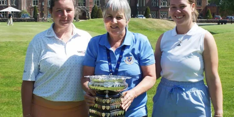 a group of women posing with a trophy