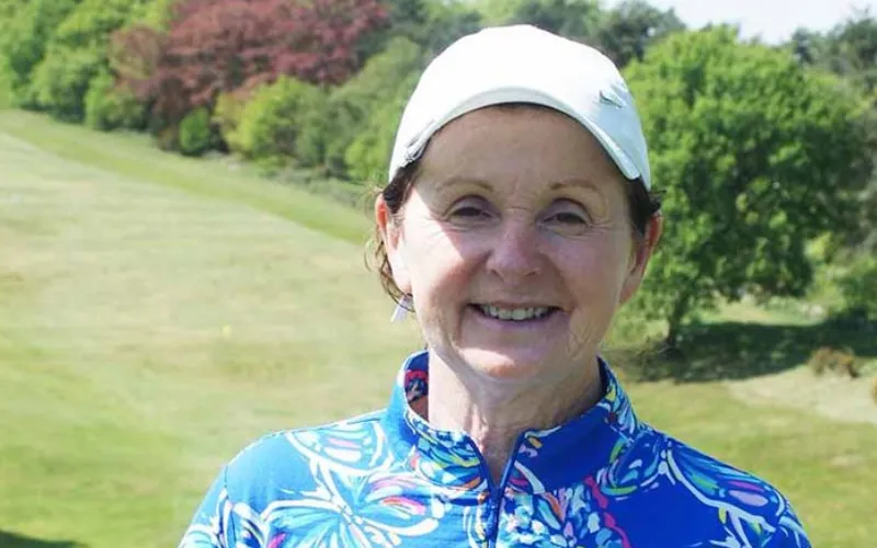 a woman wearing a white cap and blue shirt