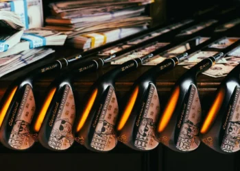 Golf clubs with cash-themed designs.