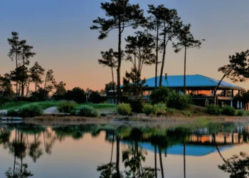 a house next to a body of water