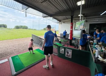 a man and child playing golf