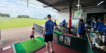 a man and child playing golf