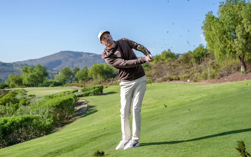 a man swinging a golf club