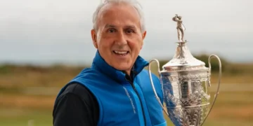 a man holding a trophy