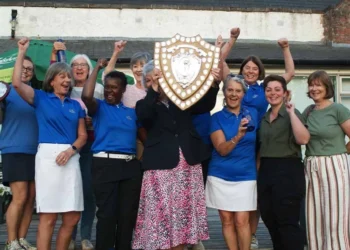 a group of women holding a shield