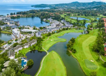 a golf course with water and buildings