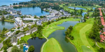 a golf course with water and buildings
