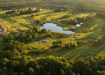 Lush golf course with serene water features.
