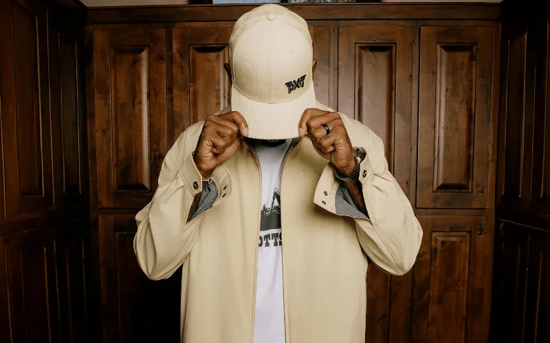 Man wearing stylish beige jacket and cap