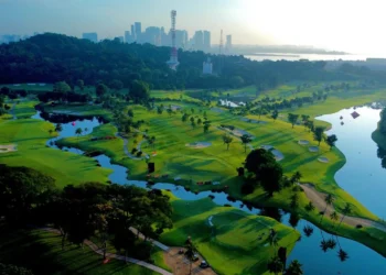 Lush golf course with city skyline backdrop