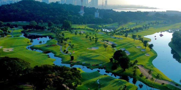 Lush golf course with city skyline backdrop