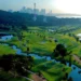 Lush golf course with city skyline backdrop