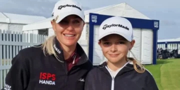 Two golfers posing in caps.