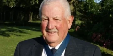 Man in suit at golf club event.