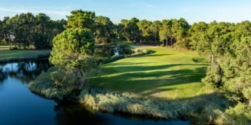 Lush golf course beside tranquil water