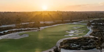 Sunset over a lush golf course.