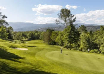 Lush golf course under blue skies.