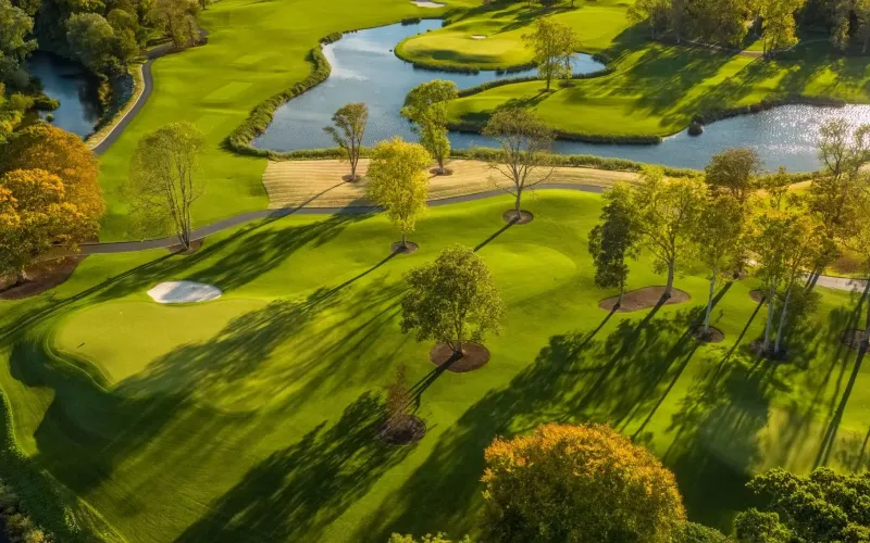 Lush green golf course with water features