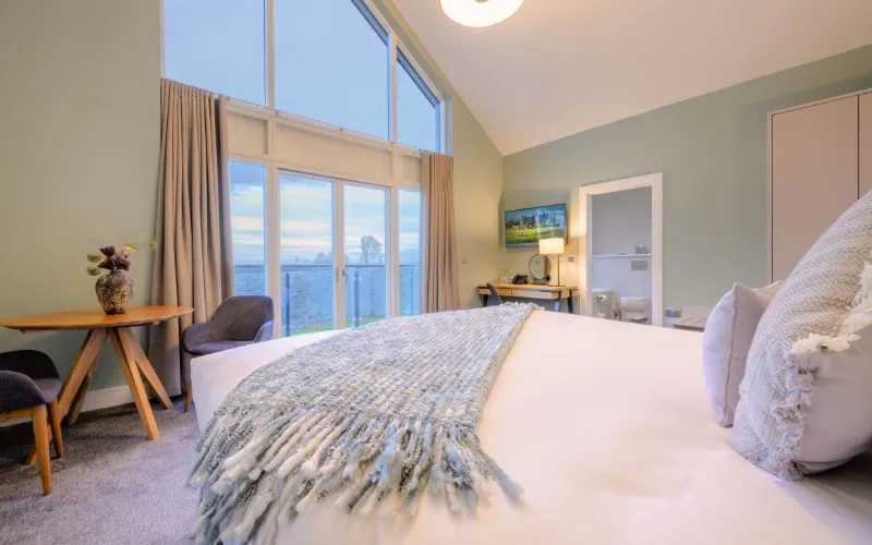 Spacious, modern bedroom with scenic views.