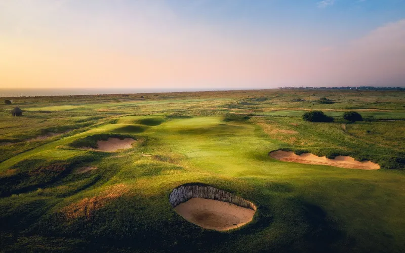 Lush green golf course at sunset