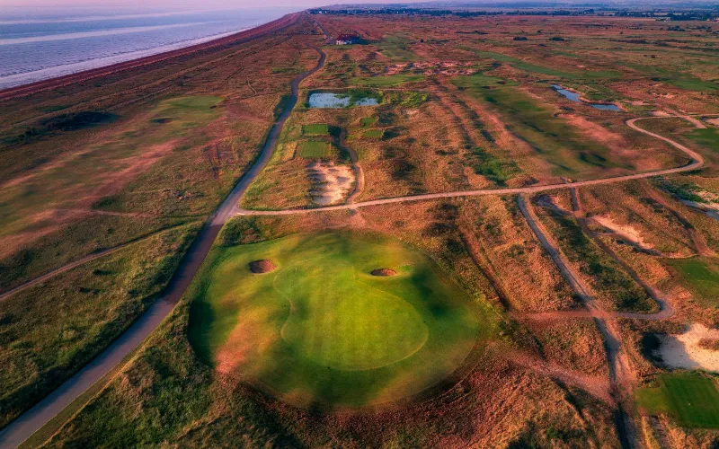 Expansive golf course by the coast.