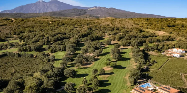Panoramic view of Picciolo Etna Golf Resort featuring the championship course with Mount Etna in the background.