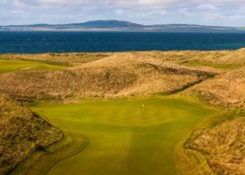 The revetted bunkers and towering dunes of The Machrie golf course on the Isle of Islay, Scotland.