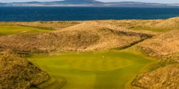 The revetted bunkers and towering dunes of The Machrie golf course on the Isle of Islay, Scotland.