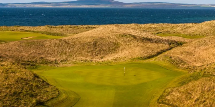The revetted bunkers and towering dunes of The Machrie golf course on the Isle of Islay, Scotland.